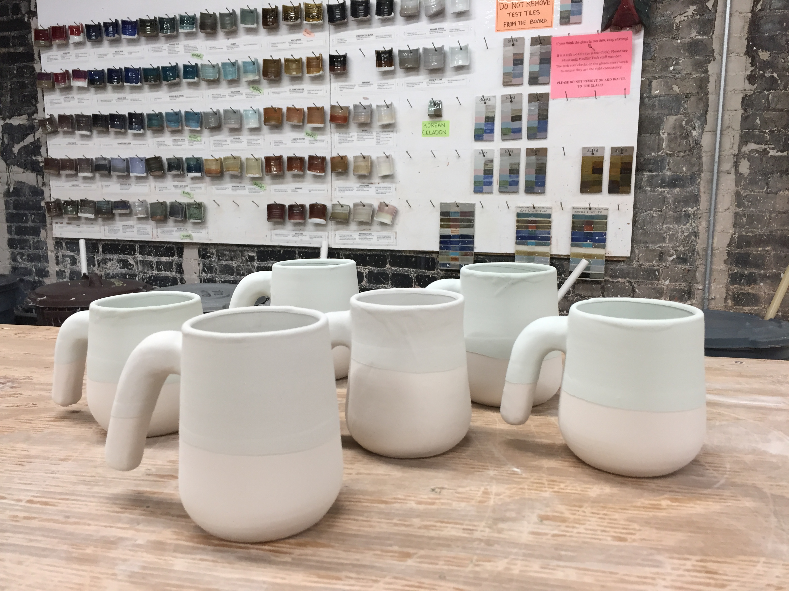 Mugs ready to be glaze fired
